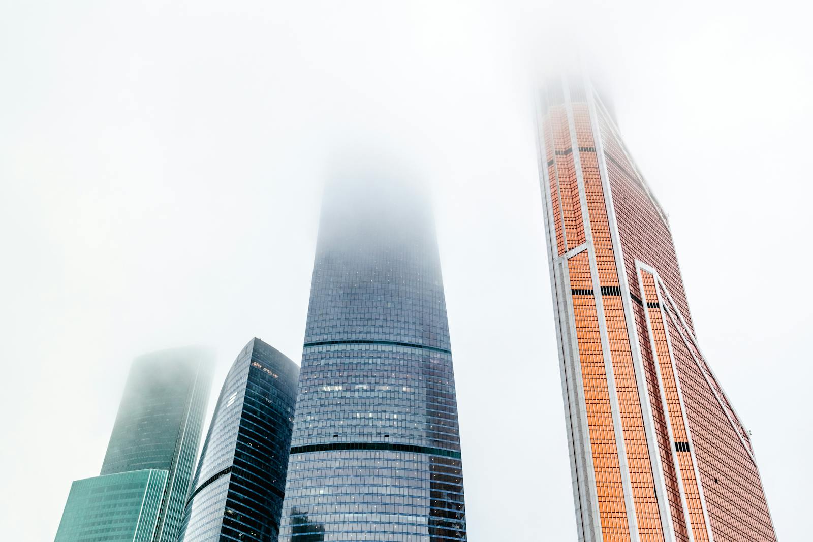 Modern skyscrapers in Moscow City rising through the fog embodying urban architecture.